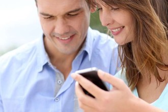 Couple looking at promotions on a tablet and smart phone