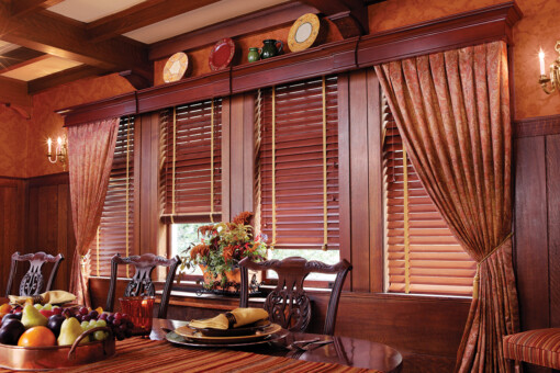 Dark dining room with windows with wooden blinds and cornices