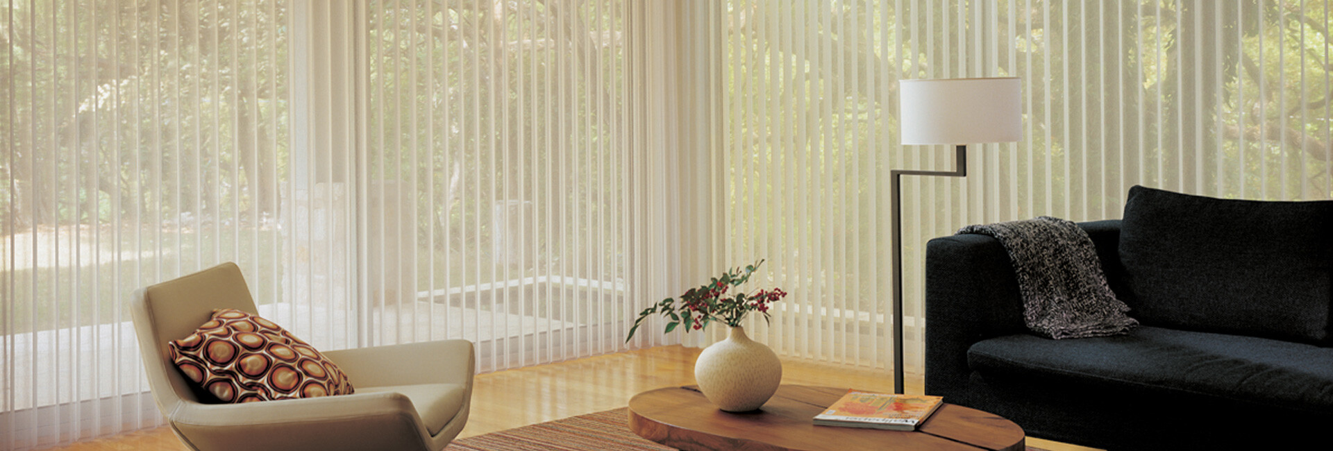 Large windows covered by sheer shades in living room