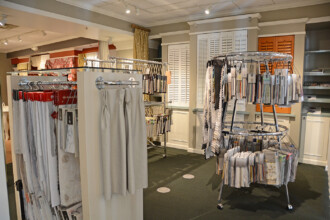 Racks of kitchen curtains and window coverings in Ambiance showroom